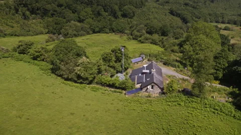 Remote off grid solar powered stone house in lush green countryside Stock Footage 336755268