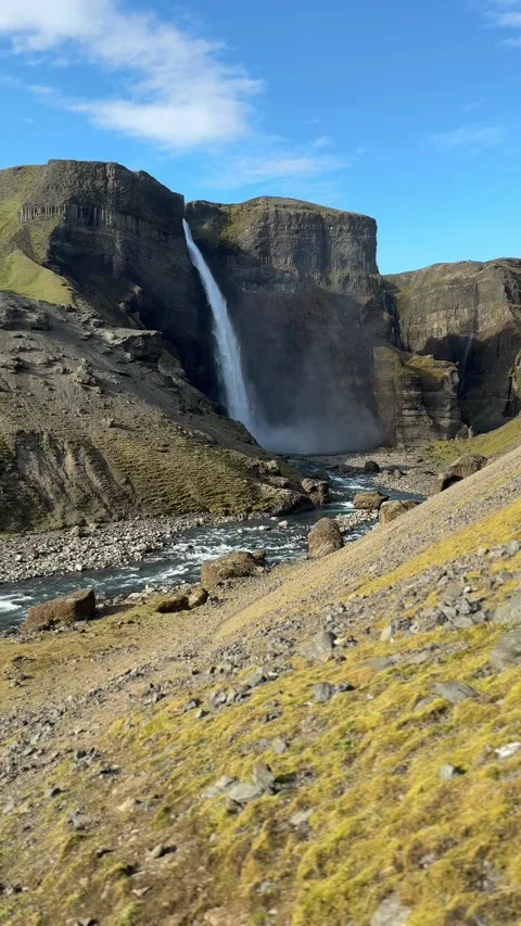 Remote Haifoss waterfall plunging into a dramatic volcanic canyon with Hekla  Stock Footage 331513910