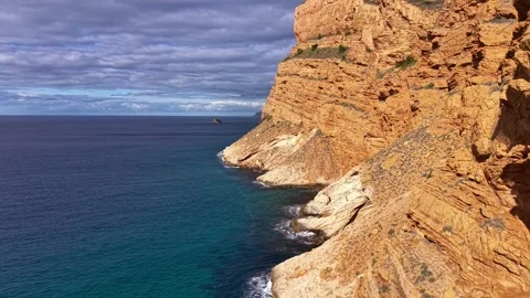 Remote Headland Featuring Textured Stratified Rocks And Powerful Ocean Waves Video stock 342405235