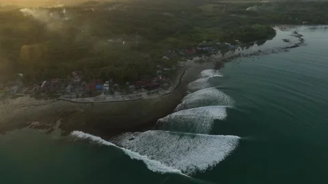 Remote Indonesia Surf Break At Sunset Drone Shot 4K Stock Footage 288567794