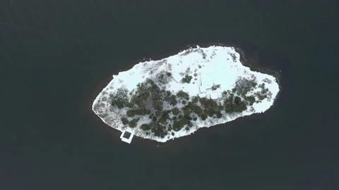 Remote island in the middle of the ocean covered in snow Stock Footage 149677972