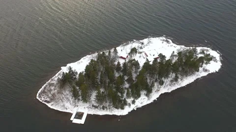 Remote island in the middle of the ocean covered in snow, aerial drone footage Stock Footage 149678621