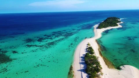 Remote island paradise featuring crystal-clear emerald sea. Видео 332824406