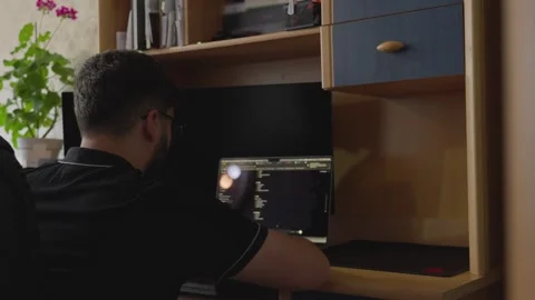 Remote IT Professional Working With Laptop and External Monitor Video stock 341767276