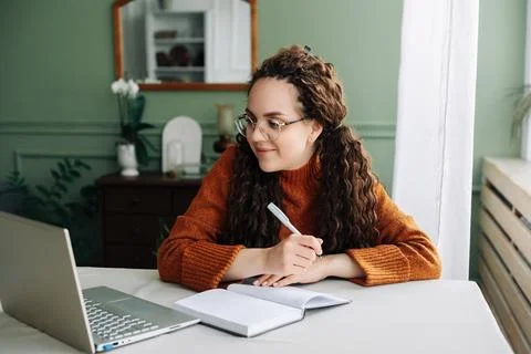 Remote Learning and Working: Young Female Student Studying Online with Laptop at Stock Photos