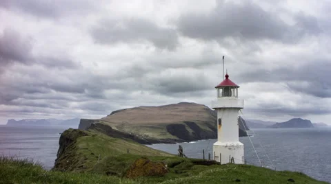 Remote lighthouse on an island with steep cliffs, Faroe Islands, 4K time lapse Video stock 65306533