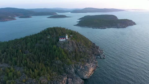 Remote Lighthouse located on a high cliff in dramatic rocky coastal landscape Stock Footage 164913005