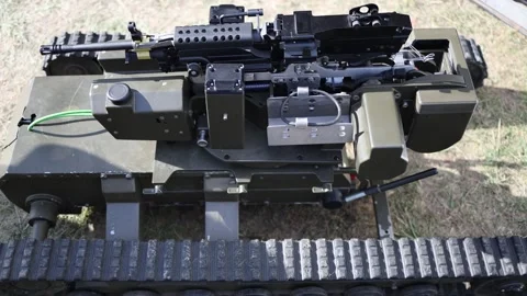 Remote machine gun station mounted on an unmanned tracked military robot Stock Footage 346451638