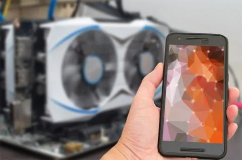 Remote mining in crypto currency concept, hand holding a smartphone Foto stock