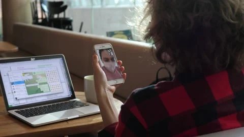 Remote mixing during covid-19 pandemic. Back view of cafe table with woman on Stock Footage 142420124