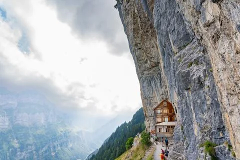 Remote Mountain Restaurant Embedded in Cliffside Swiss Alps Adventure Stock Photos