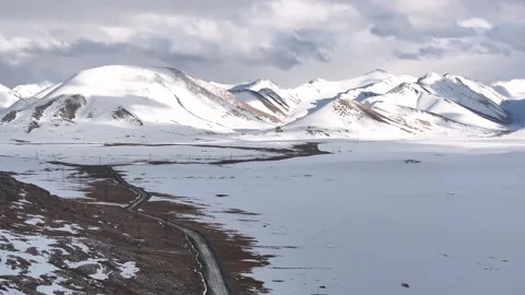 Remote mountain road to Kara Say remote settlement and snowy mountain Vídeos de archivo 339125434