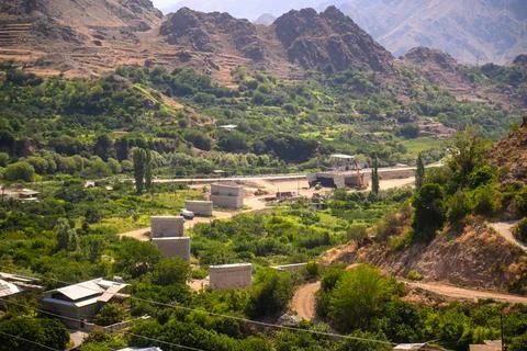 Remote mountain settlement among dense vegetation Stock Photos