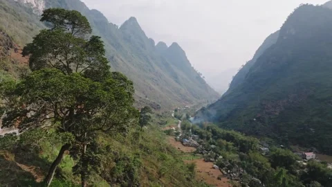 Remote Mountain Valley With River and Rural Settlement Stock Footage 345695005