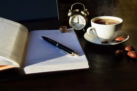 Remote online work, business concept laptop with diary and a cup of tea. Stock Photos
