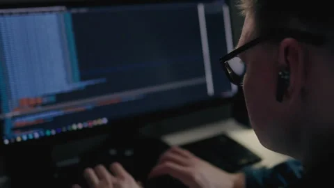 Remote part-time job, a young man actively works at home, the work of an IT Stock Footage 243004575