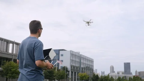 Remote Pilot Flies Drone Near City Stock Footage 94184082