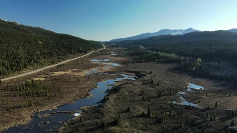 Remote road through a mountain meadow pass, drone shot Stock Footage 289576830