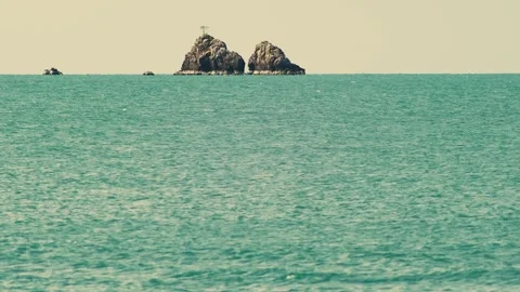 Remote Rocky Islets Rising Above Tropical Sea Under Clear Morning Sky Vídeos de archivo 337528913