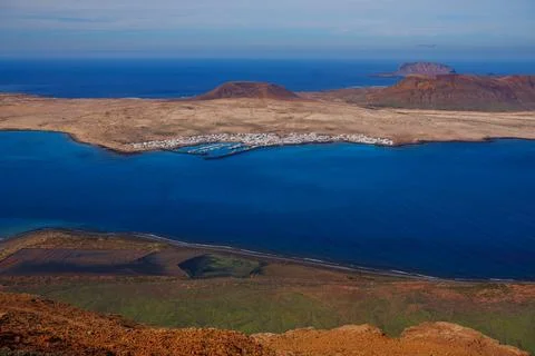 Remote seaside settlement, calm waters, volcanic landscape. Lanzarote 스톡 사진