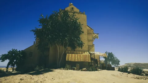 Remote settlement featuring adobe architecture and contrasting lighting effects Stock Footage 342427797