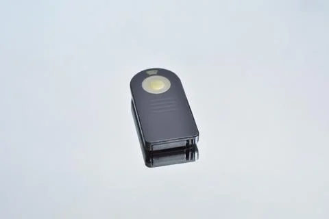 Remote shutter release control for the camera, and its reflection on the mirr Stock Photos