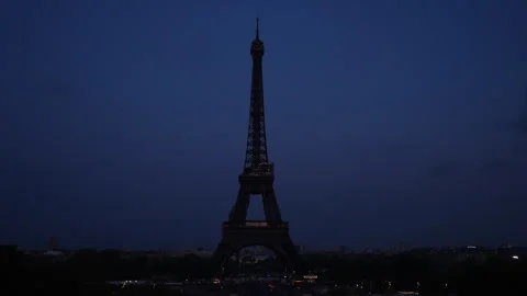 Remote silhouette of the Eiffel Tower without lighting against dark sky. Iconic Stock Footage 241597531