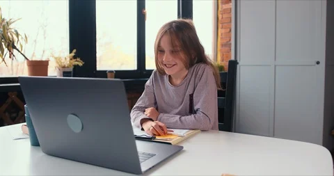 Remote studies on lockdown, beautiful smart Caucasian teen girl speaking to Stock Footage 129279058