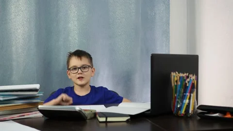 Remote study at home. a boy sitting on a chair imagines himself flying into the Stock Footage 145317357