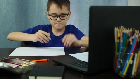 Remote study at home. the boy writes on paper Stock Footage 144935080