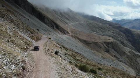 Remote SUV Journey Along a Winding Mountain Trail at Baros Pass Видео 333028668
