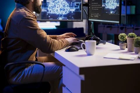 Remote tech support specialist at working from home, doing checkup on AI systems Stock Photos