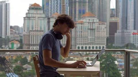 Remote techer has a conversation with a student through the internet at a Video stock 100105255