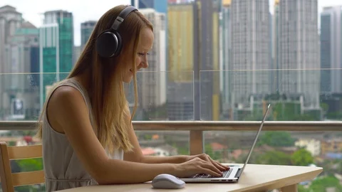 Remote techer has a conversation with a student through the internet at a Video stock 100105801