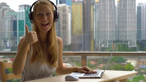 Remote techer has a conversation with a student through the internet at a Video stock 100106446