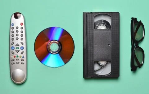 Remote from the TV, 3d glasses, CD drive, vhs on mint color pastel background Stock Photos