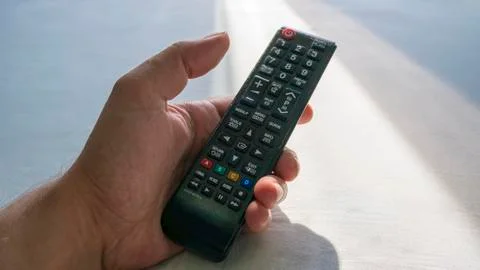 The remote tv in hand Stock Photos