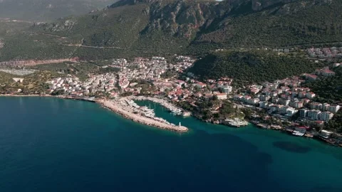 Remote view from a drone, marina with hotels on the coast, mountains, 4k yachts Video stock 215227647