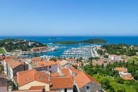 A remote view on the harbour from a hill. Rows of docks waiting for the boats Stock Photos