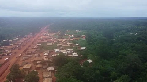 Remote Village Bordering Dense Rainforest, Featuring Dusty Road and Simple Stock Footage 315255989
