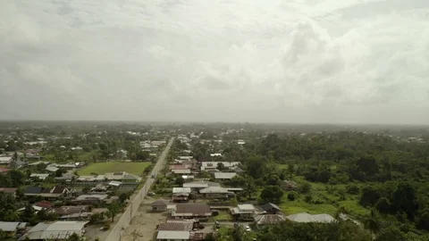 Remote village town in Java, Indonesia, on overcast day, aerial rising view Vídeo Stock 124002205