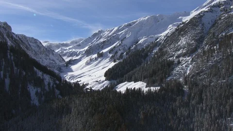 A remote winter valley opens up with mountains and snow Stock Footage 101898067