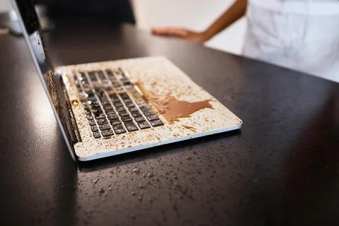 Remote work, accident and coffee splash on laptop in a kitchen, crisis and Stock Photos