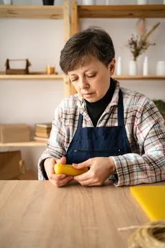 Remote work and commerce concept. Woman making beeswax candles, vegan busin.. Stock Photos