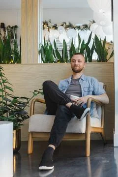 Remote work can be done in a cozy space with plants, a cup of coffee, and a.. Stock Photos