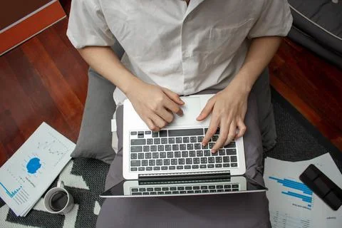 Remote work concept, Male freelancer use laptop to typing business data and w Stock Photos