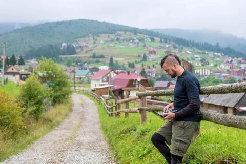 Remote work concept: a man working on a laptop outdoors. Stock Photos