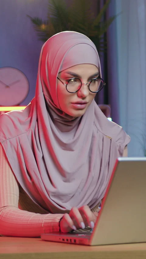 Remote work concept where beautiful concentrated tired young arabic lady in ligh Stock Footage 328030823
