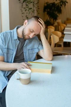 Remote work environment with a person studying at a table in a modern space.. Foto stock