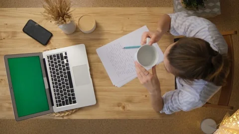 Remote work, get a drink of water. The woman works remotely and is trained. I to Stock Footage 148532145